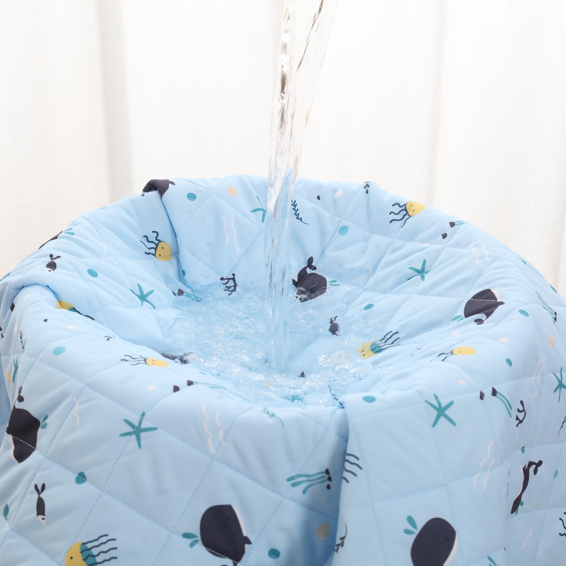 Rudie Baby leakproof bed guard in Whales print, hanging display