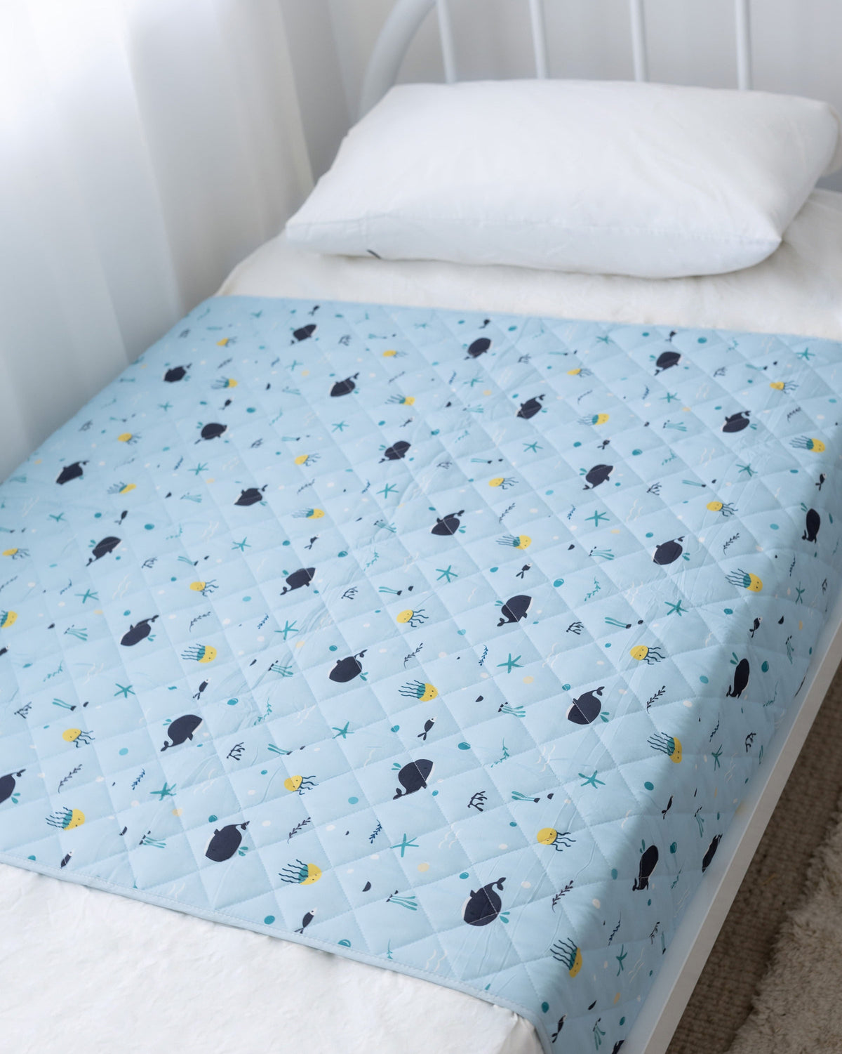 Rudie Baby leakproof bed guard on bed, lifestyle photo